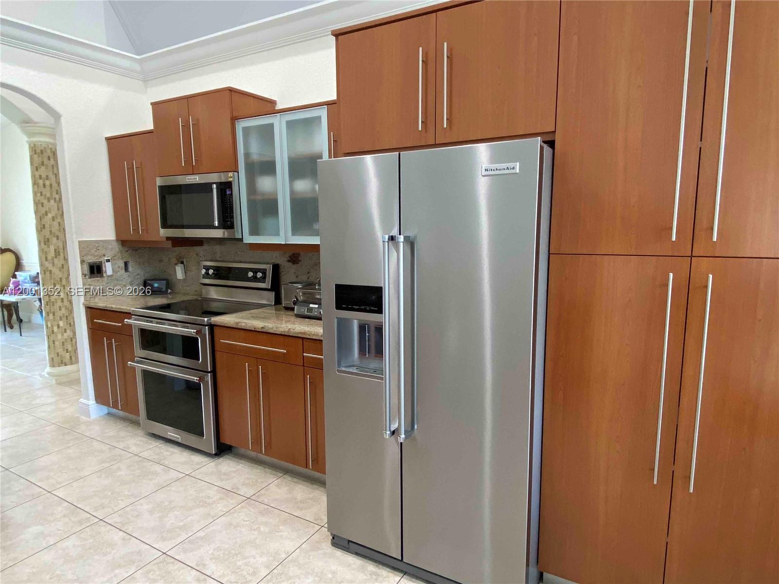 14302 Southwest 15th Street Miami, FL 33184 - Photo 24 of 63 a kitchen with stainless steel appliances granite countertop a refrigerator stove a sink and dishwasher