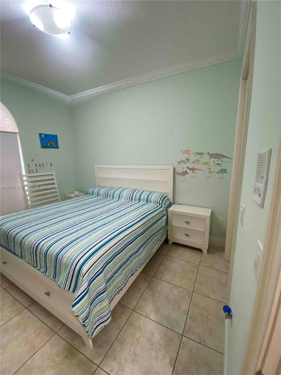 14302 Southwest 15th Street Miami, FL 33184 - Photo 27 of 63 a bedroom with a bed and a table