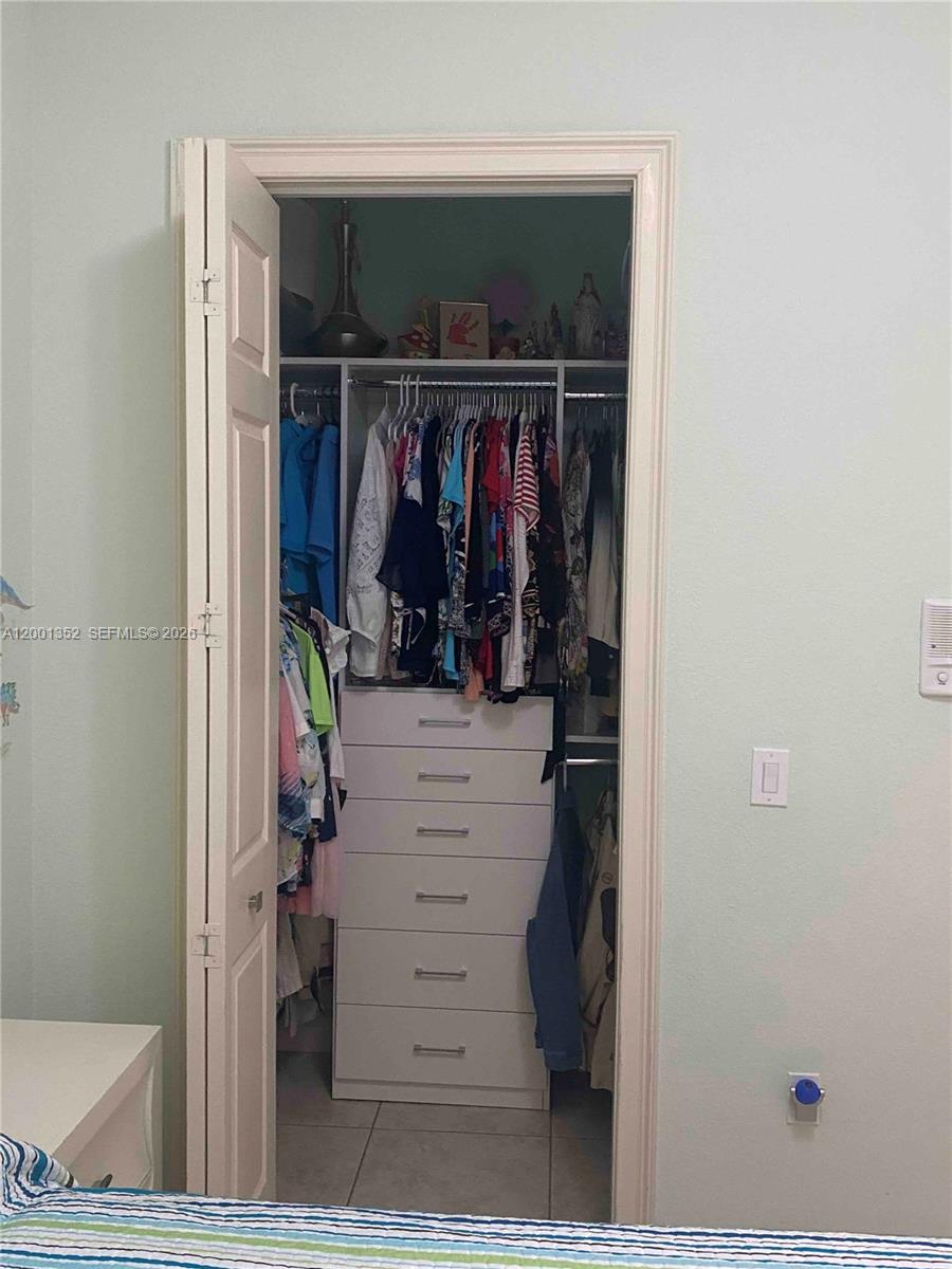 14302 Southwest 15th Street Miami, FL 33184 - Photo 28 of 63 a view of walk in closet with clothes