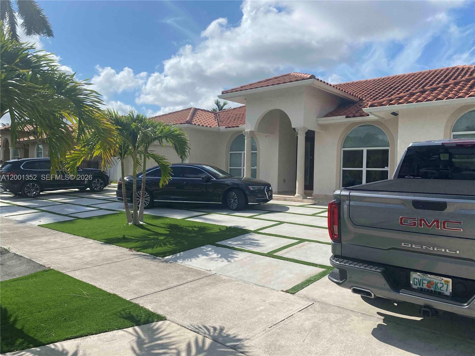 14302 Southwest 15th Street Miami, FL 33184 - Photo 3 of 63 a front view of a house with a garden