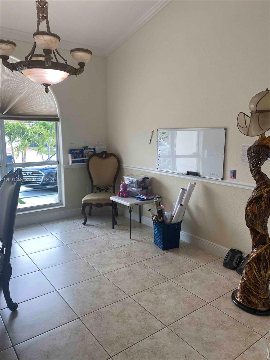 14302 Southwest 15th Street Miami, FL 33184 - Photo 41 of 63 a living room with furniture and a window