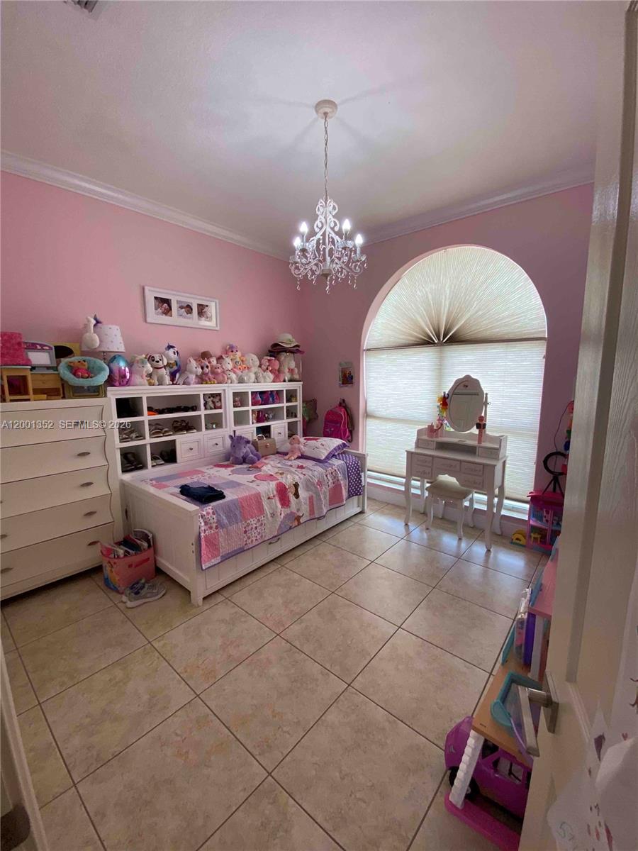 14302 Southwest 15th Street Miami, FL 33184 - Photo 53 of 63 a bedroom with furniture and a mirror