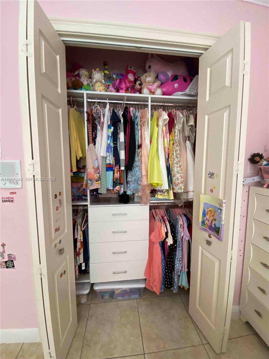 14302 Southwest 15th Street Miami, FL 33184 - Photo 54 of 63 a view of walk in closet with clothes