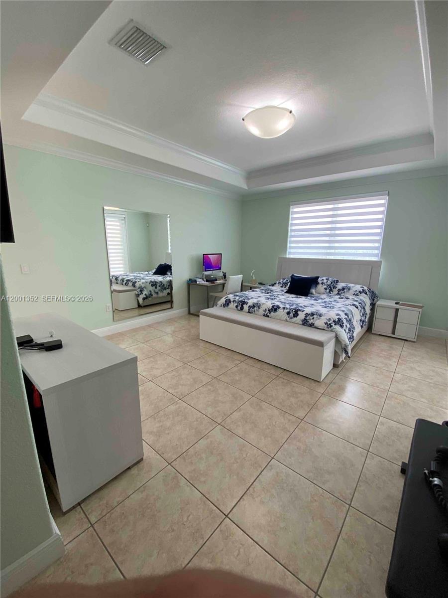 14302 Southwest 15th Street Miami, FL 33184 - Photo 57 of 63 a living room with furniture and a flat screen tv