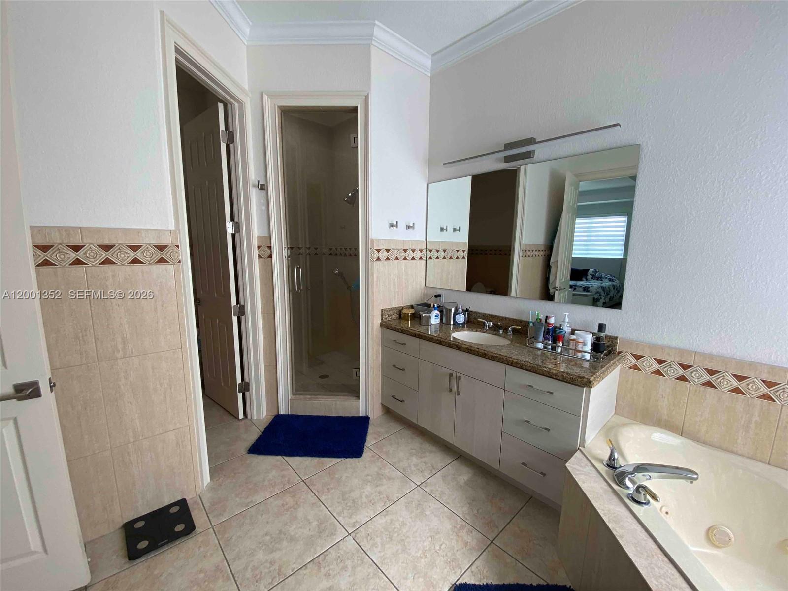 14302 Southwest 15th Street Miami, FL 33184 - Photo 61 of 63 a bathroom with a tub sink and mirror