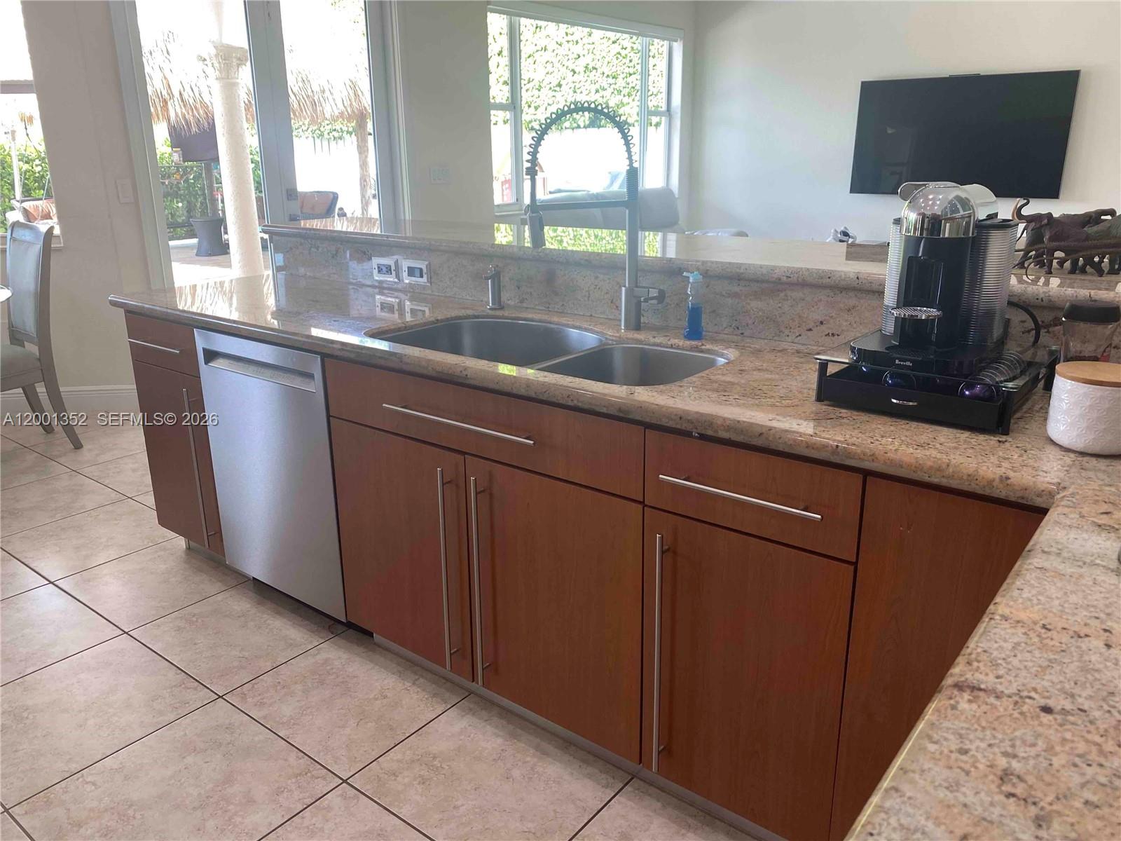14302 Southwest 15th Street Miami, FL 33184 - Photo 63 of 63 a kitchen with sink and large window