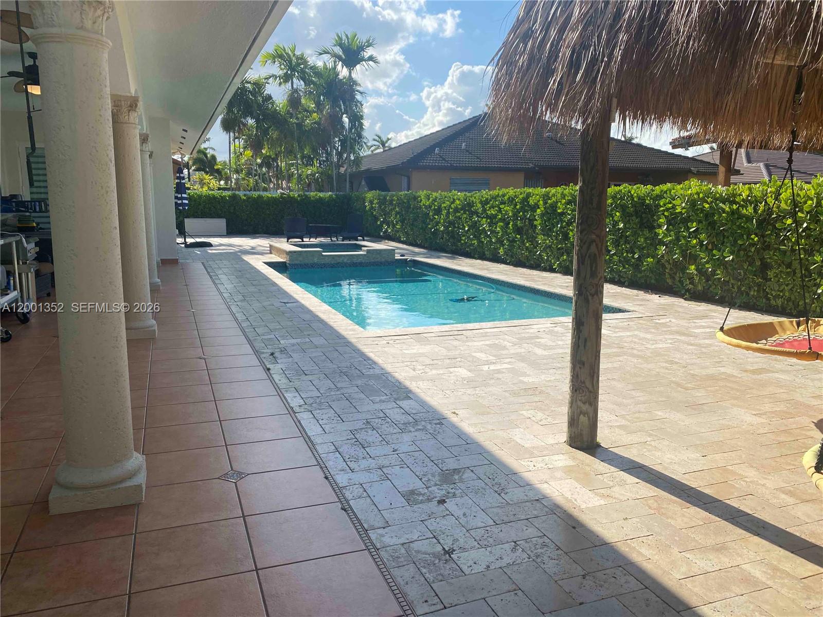 14302 Southwest 15th Street Miami, FL 33184 - Photo 10 of 63 a view of a swimming pool with a patio