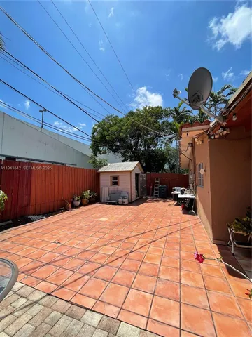 a front view of a house with plants