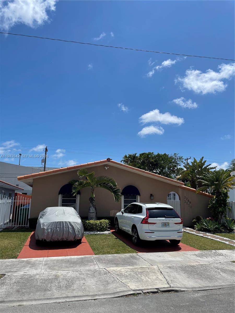 3270 Southwest 7th Street Miami, FL 33135 - Photo 14 of 25 a front view of a house with cars parked