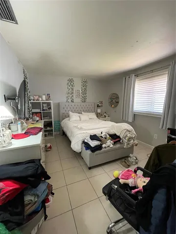 a bedroom with bed and a couch