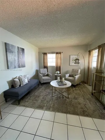 a living room with furniture and a rug