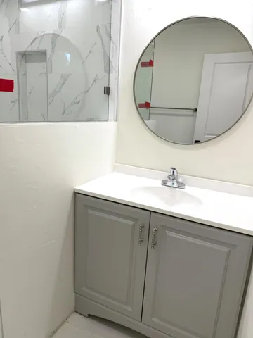 a bathroom with a sink and mirror
