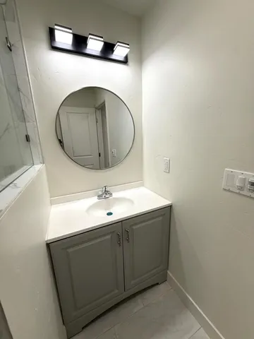 a bathroom with a sink and a mirror