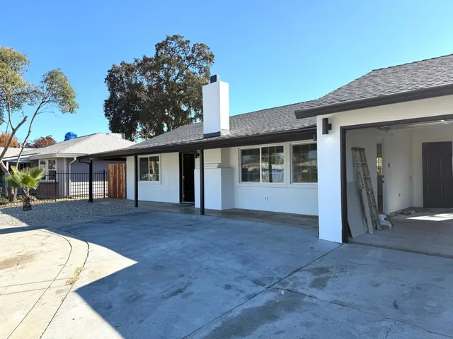 a view of house with yard and entertaining space