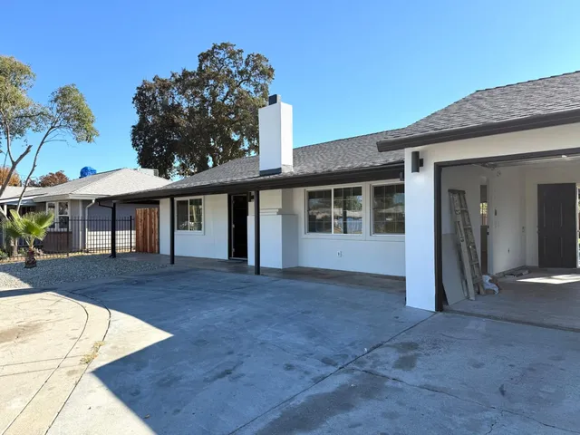 a view of house with yard and entertaining space