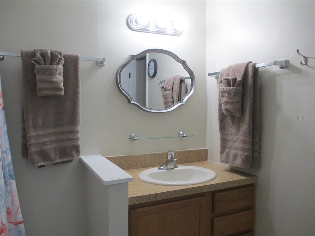 4469 Keyes Avenue Spring Hill, FL 34606 - Photo 15 of 27 a bathroom with a sink and a mirror