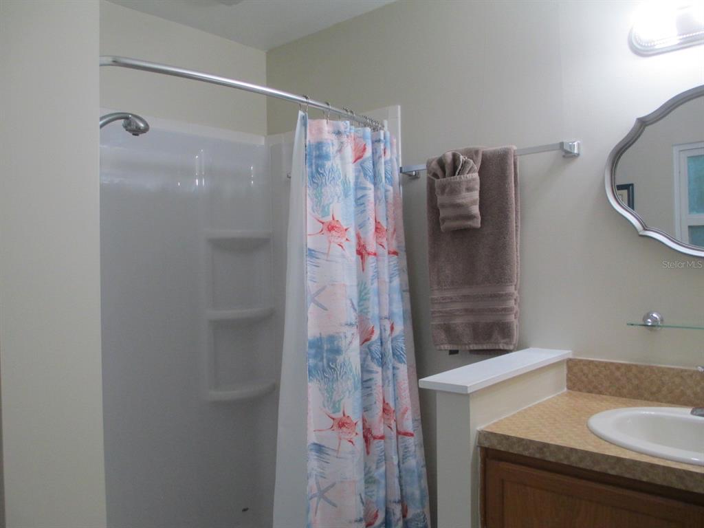 4469 Keyes Avenue Spring Hill, FL 34606 - Photo 16 of 27 a bathroom with a sink and mirror