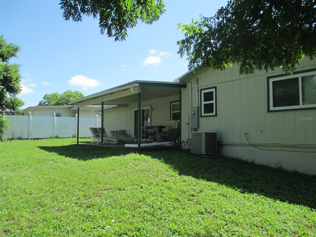 4469 Keyes Avenue Spring Hill, FL 34606 - Photo 5 of 27 a view of a backyard with plants and large trees
