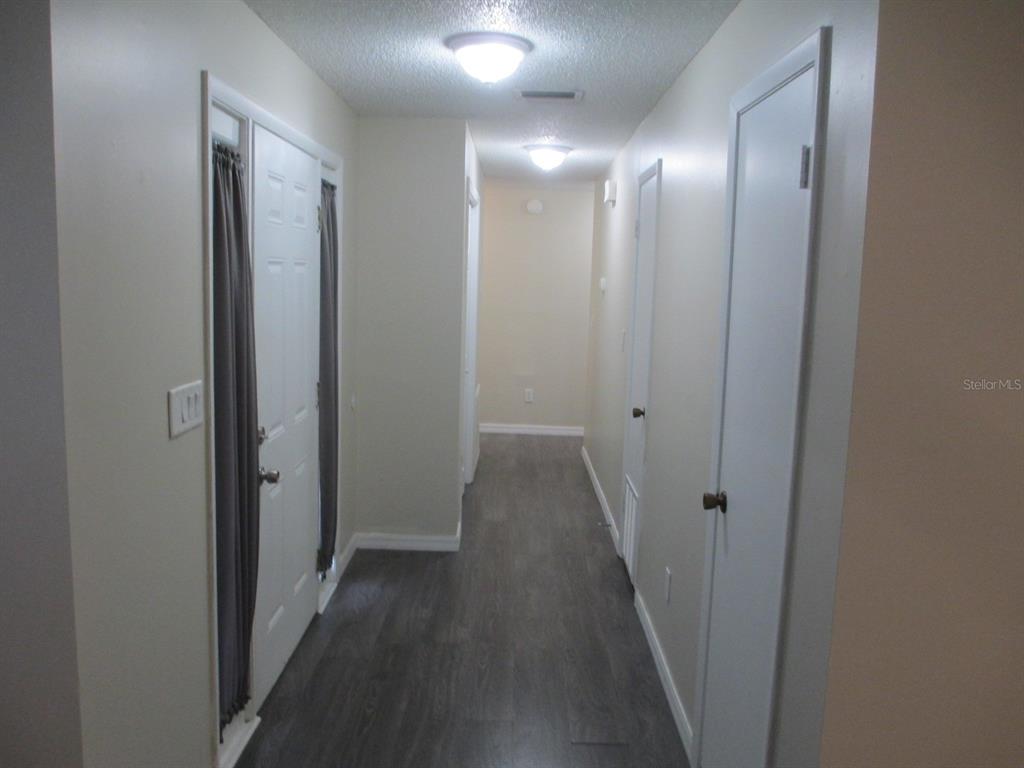 4469 Keyes Avenue Spring Hill, FL 34606 - Photo 10 of 27 a view of a hallway with wooden floor