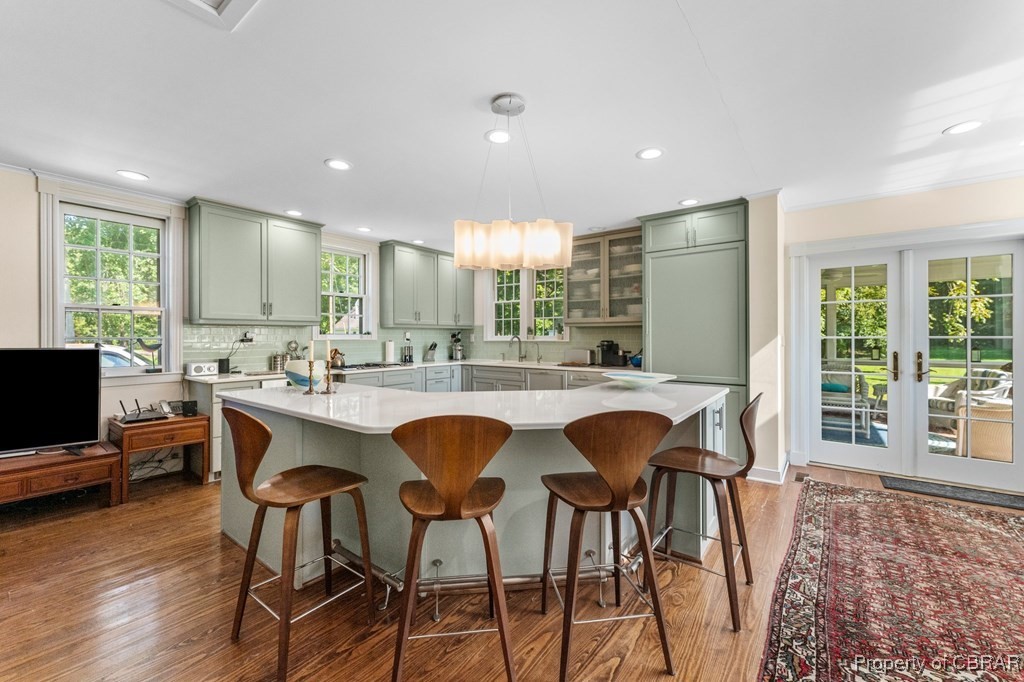 1701 Balls Neck Road Kilmarnock, VA 22482 - Photo 33 of 50 Kitchen featuring dark hardwood / wood-style flooring, green cabinets, hanging light fixtures, and a center island