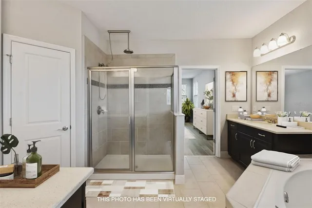a spacious bathroom with a shower sink and mirror