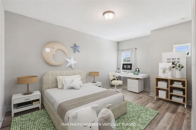 a bedroom with a bed a table and chair