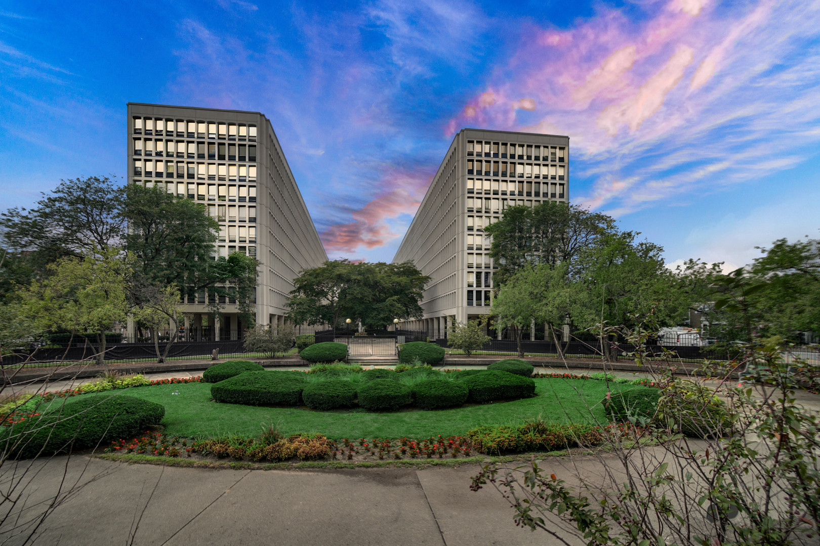 1401 East 55th Street, Unit 313N Chicago, IL 60615 - Photo 1 of 20 a front view of a residential apartment building with a yard