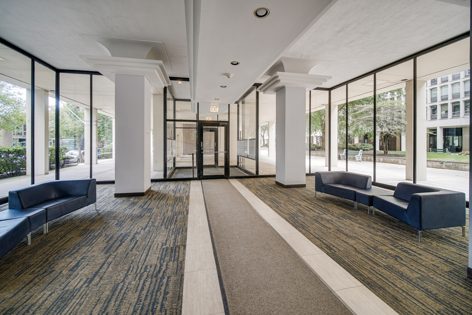 1401 East 55th Street, Unit 313N Chicago, IL 60615 - Photo 13 of 20 a spacious bedroom with a large window and a wooden floor