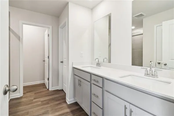 a bathroom with a double vanity sink and a mirror