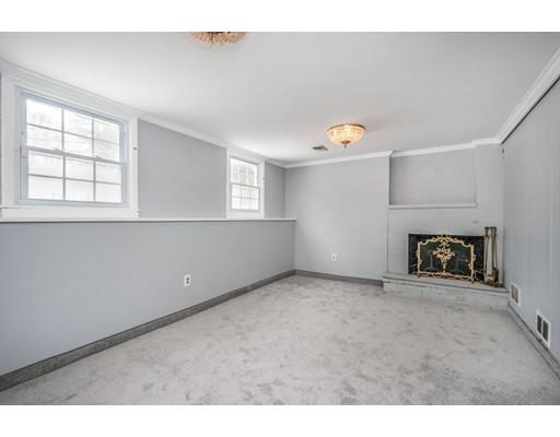 6 Woodmere Road Framingham, MA 01701 - Photo 12 of 15 a view of an empty room with a fireplace and a window