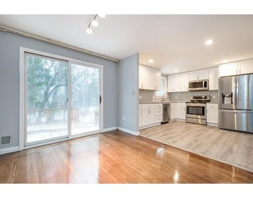 6 Woodmere Road Framingham, MA 01701 - Photo 3 of 15 a kitchen with a refrigerator a stove top oven and a large window
