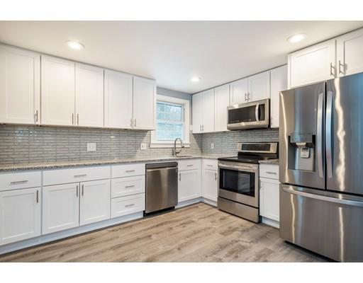 6 Woodmere Road Framingham, MA 01701 - Photo 4 of 15 a kitchen with stainless steel appliances granite countertop a refrigerator a stove a sink and white cabinets