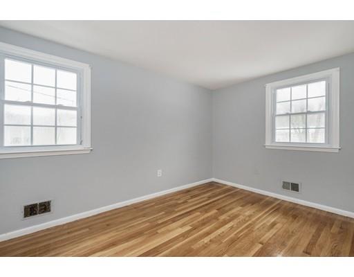 6 Woodmere Road Framingham, MA 01701 - Photo 6 of 15 an empty room with wooden floor and windows