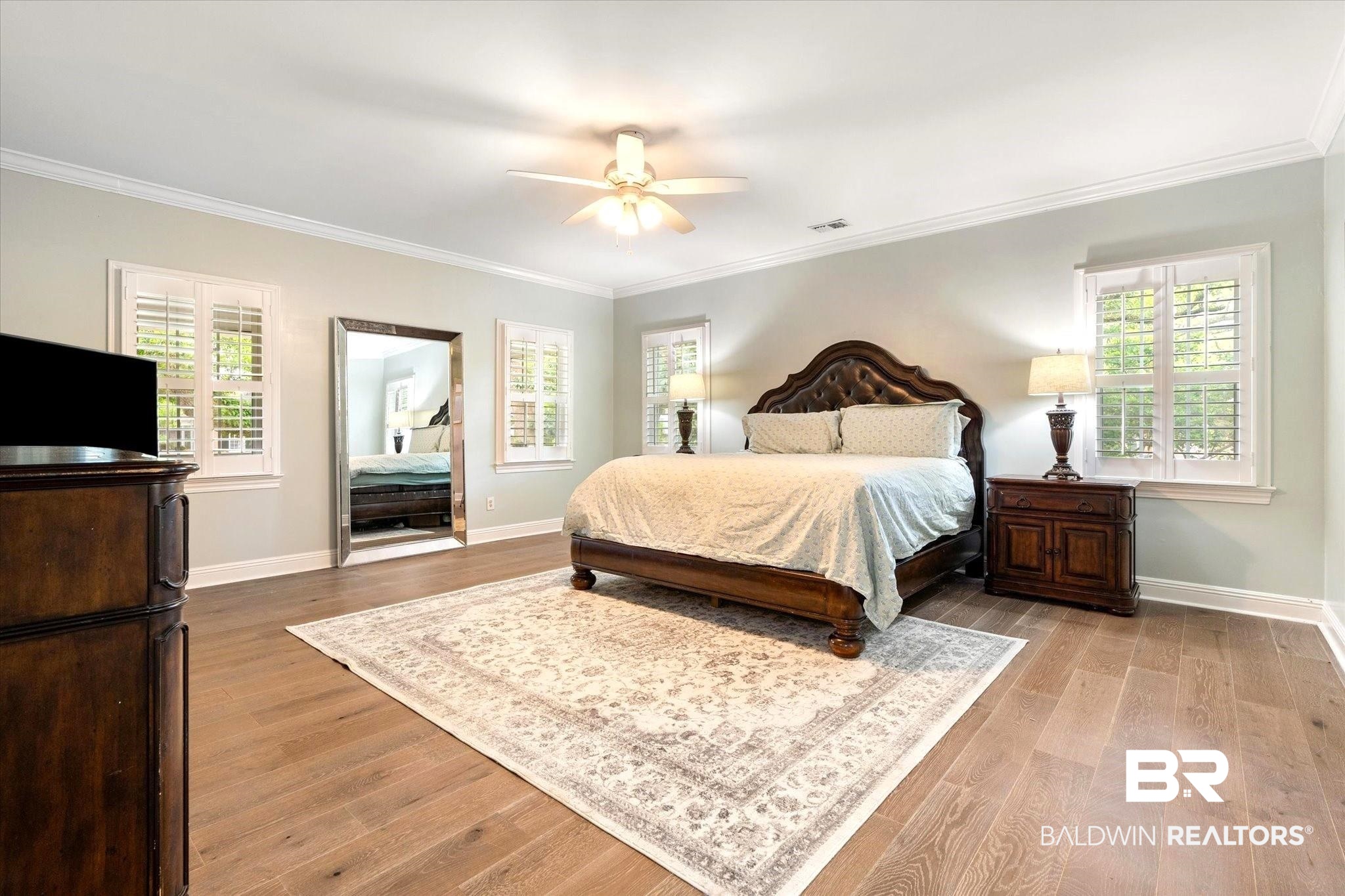 5324 Oak Bend Court Mobile, AL 36609 - Photo 21 of 49 Bedroom with visible vents, multiple windows, and wood finished floors