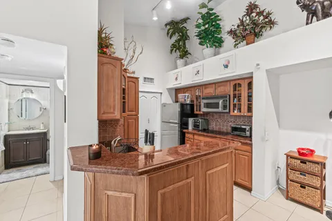 a kitchen with stainless steel appliances kitchen island granite countertop a sink and cabinets