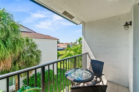 a view of a chair and table in the balcony