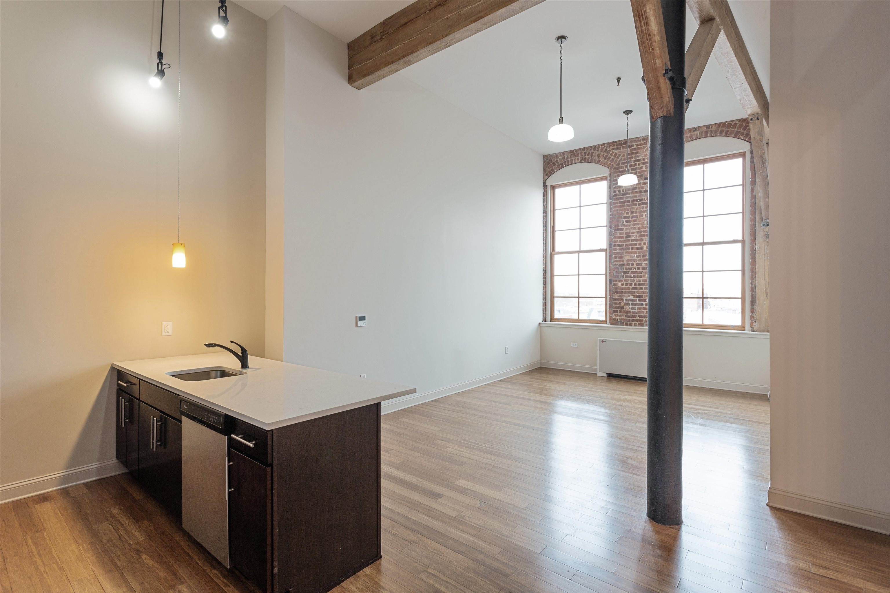 154 Ave East, Unit A501 Bayonne, NJ 07002 - Photo 5 of 19 a kitchen with a stove and wooden floor