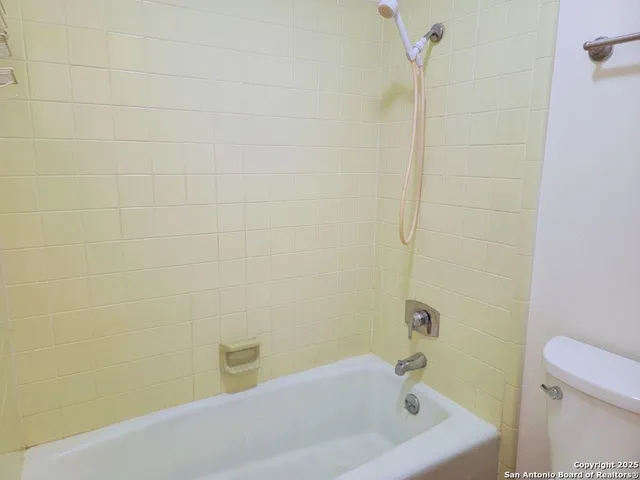 a bathroom with a white bathtub