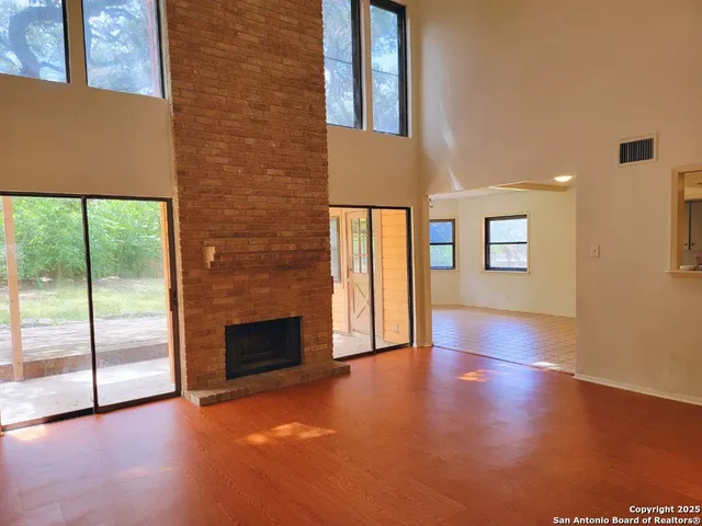 a view of an empty room with glass door