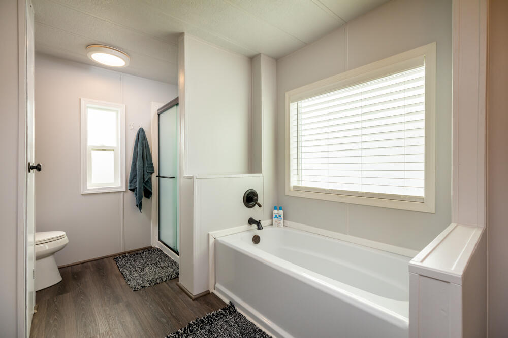 8757 Reeder Road Klamath Falls, OR 97603 - Photo 8 of 34 a bathroom with a bathtub and a toilet