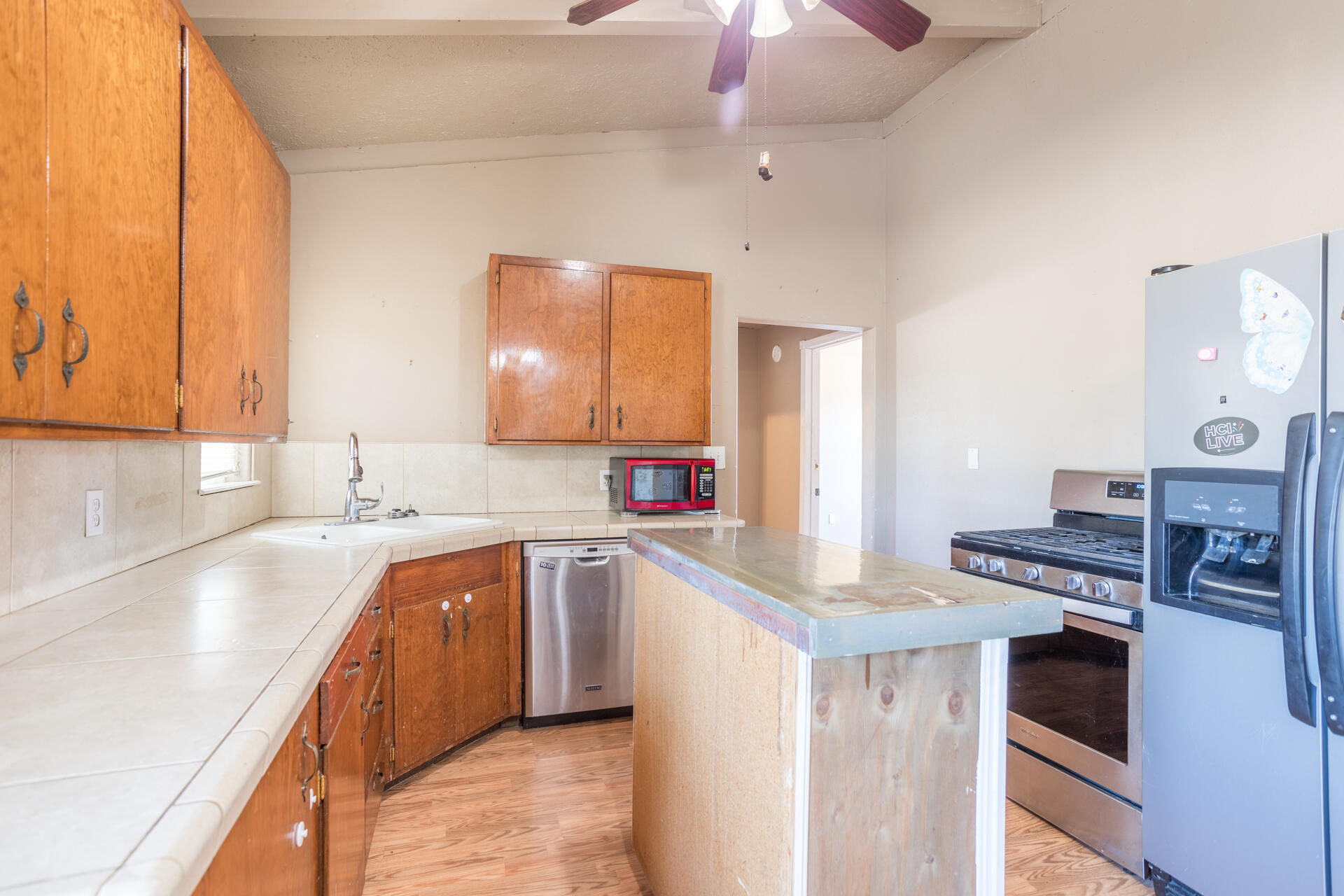 12141 Cinder Road Redding, CA 96003 - Photo 13 of 23 a kitchen with stainless steel appliances a sink stove and cabinets