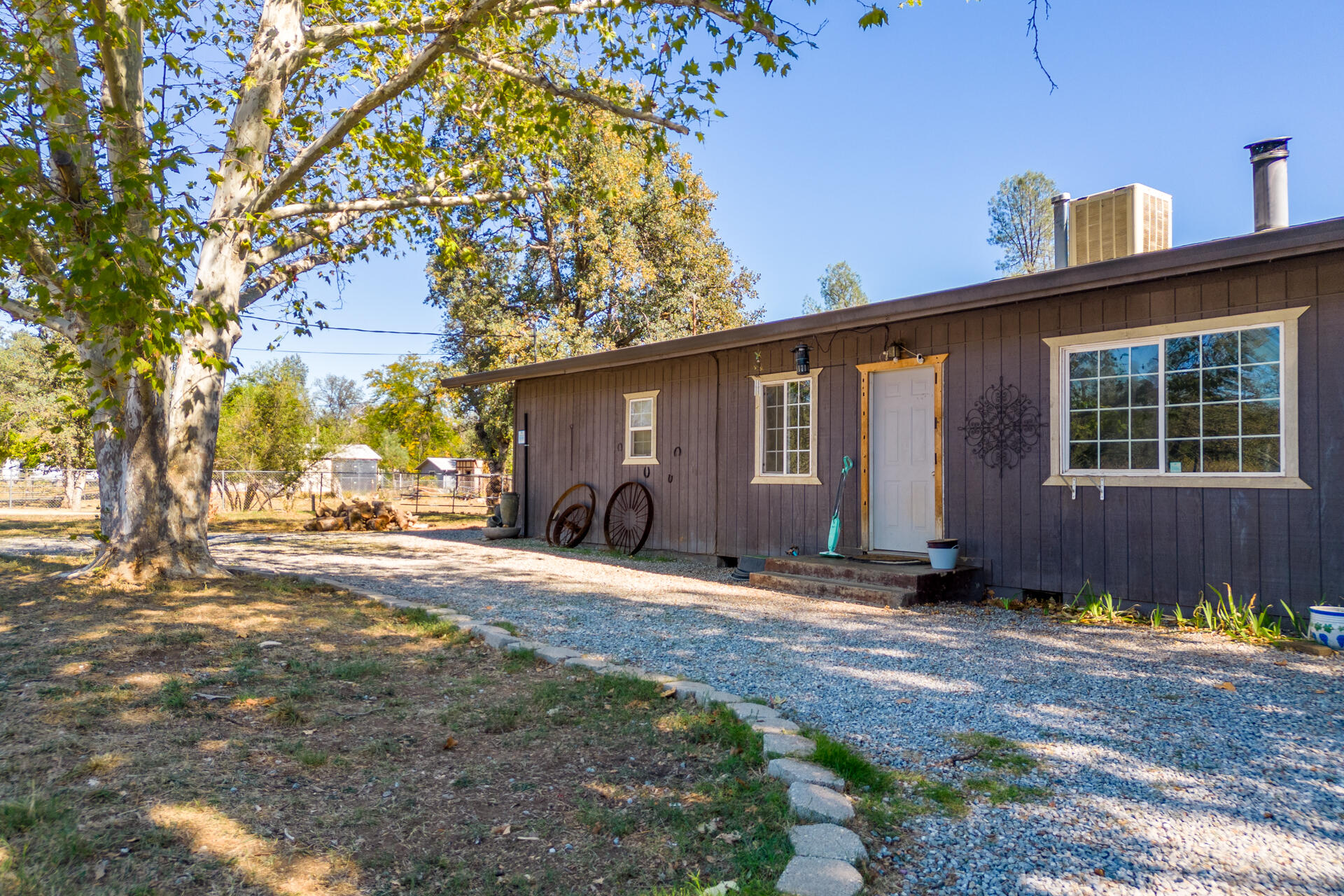 12141 Cinder Road Redding, CA 96003 - Photo 16 of 23 a backyard of a house with yard and outdoor seating