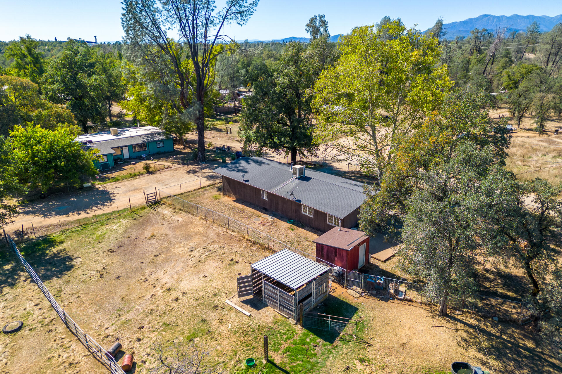 12141 Cinder Road Redding, CA 96003 - Photo 2 of 23 a view of a backyard with a patio
