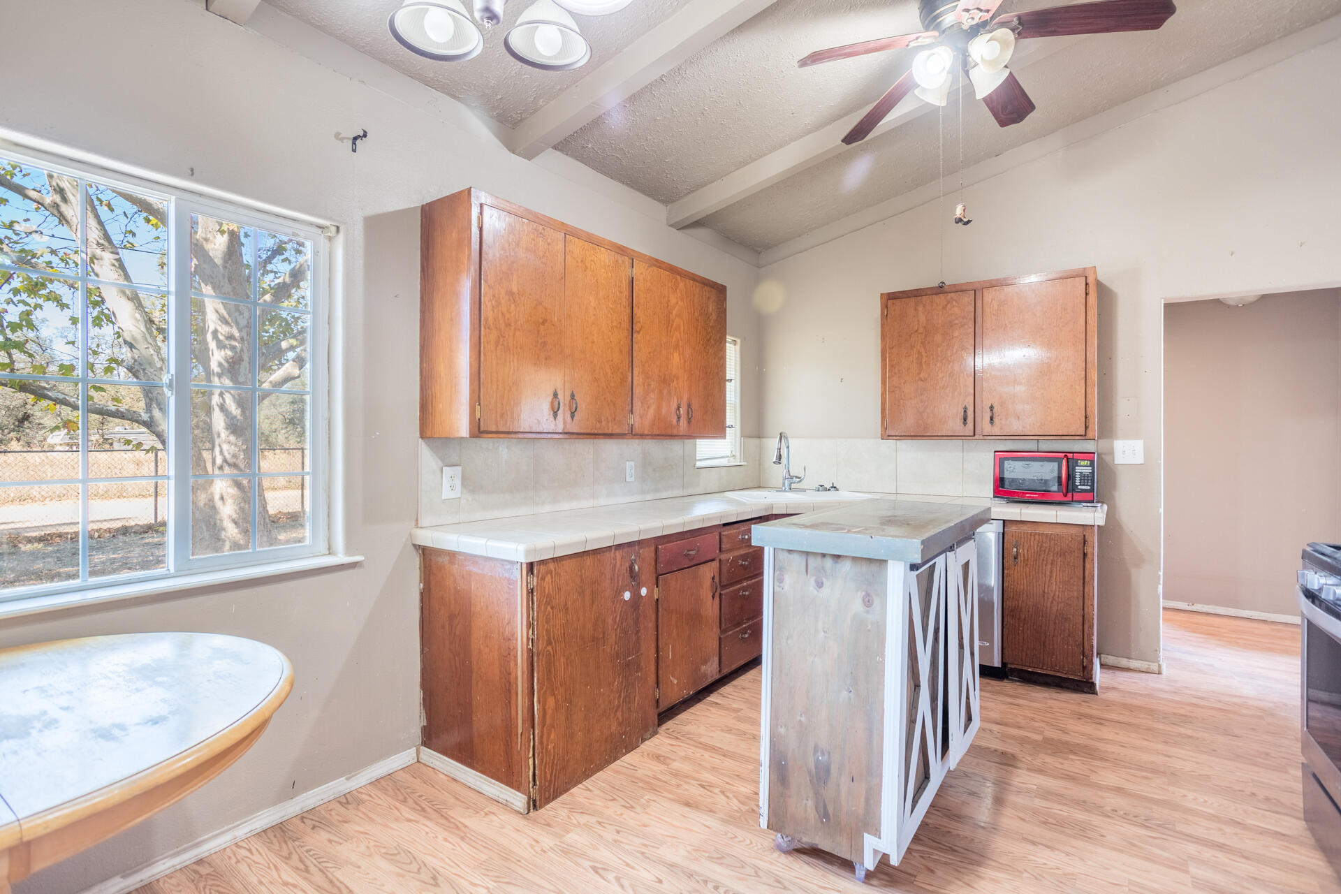 12141 Cinder Road Redding, CA 96003 - Photo 23 of 23 a kitchen that has a sink a stove and a wooden floor