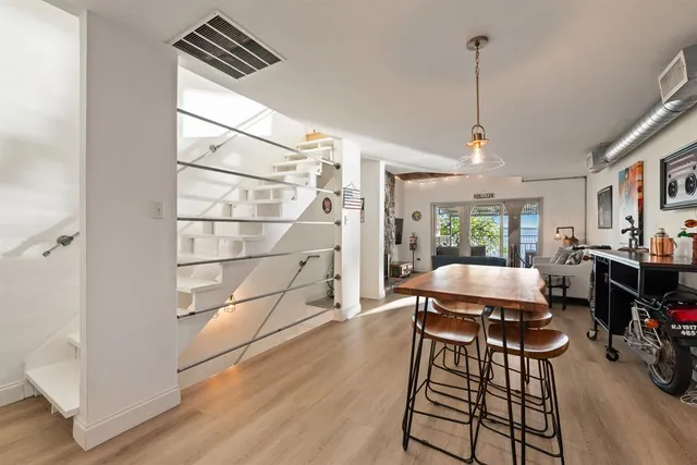 a outdoor space with wooden floor barbeque oven a table and chairs