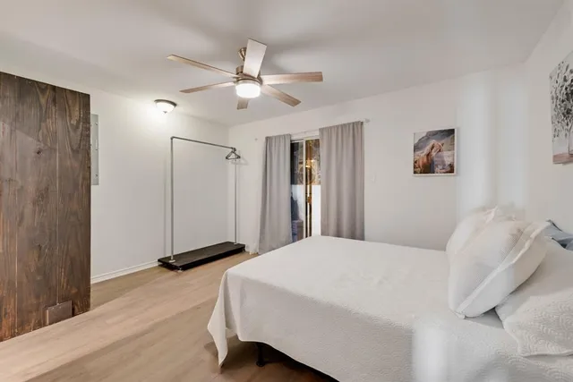 a bedroom with a large bed and a chandelier