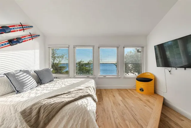 a bedroom with a bed and flat screen tv