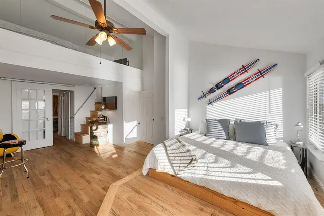 a bedroom with a bed and a chandelier