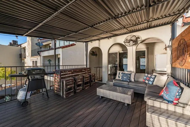 a outdoor space with lots of furniture and wooden floor