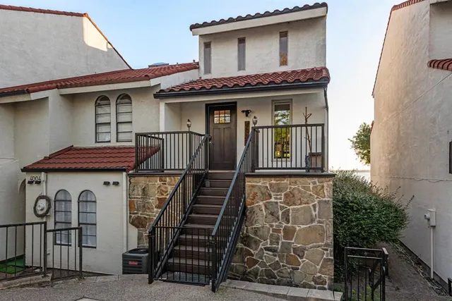 a front view of a house with large windows